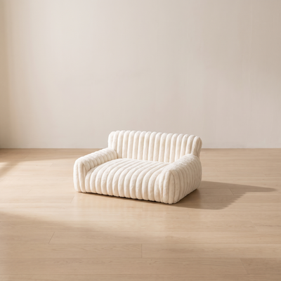 Loveseat cat couch in a minimal room with pale oak floor