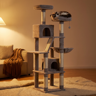 Strata cat tree tower in warm evening light with a cat curled asleep in the hammock